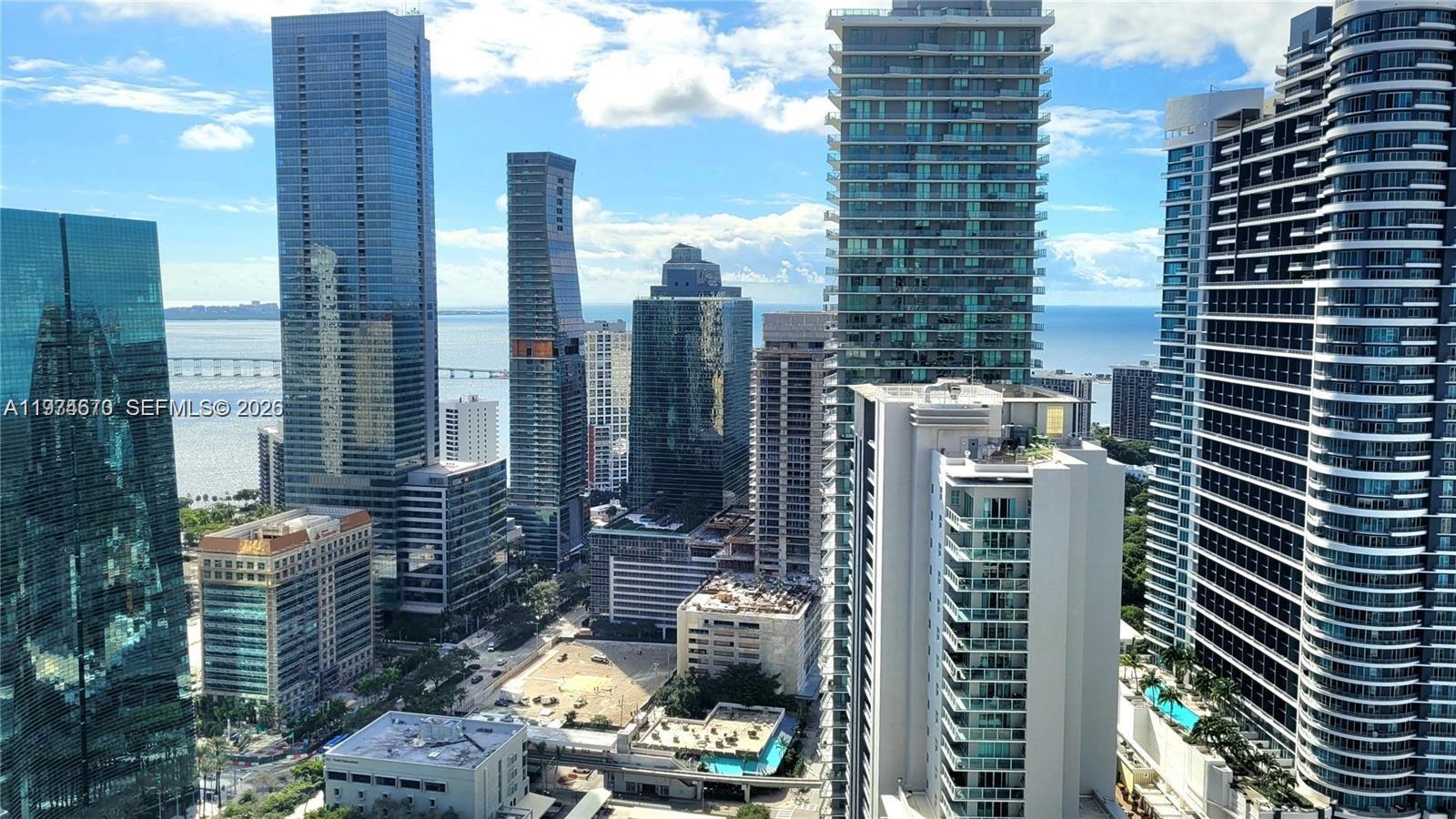 An elevated view of a dense urban skyline featuring multiple high-rise glass skyscrapers and water — 1100 S Miami Ave # 4201, Miami FL 33130, MIAMI, FL