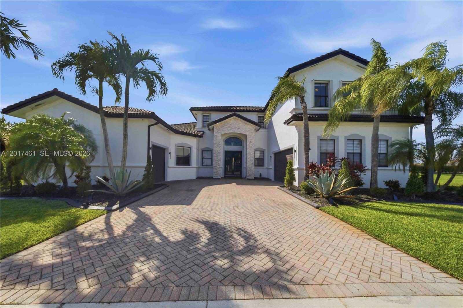 A two-story house with a stone entryway, a brick driveway, and palm trees — 1748 SW 195th Ave, Miramar FL 33029, MIRAMAR, FL