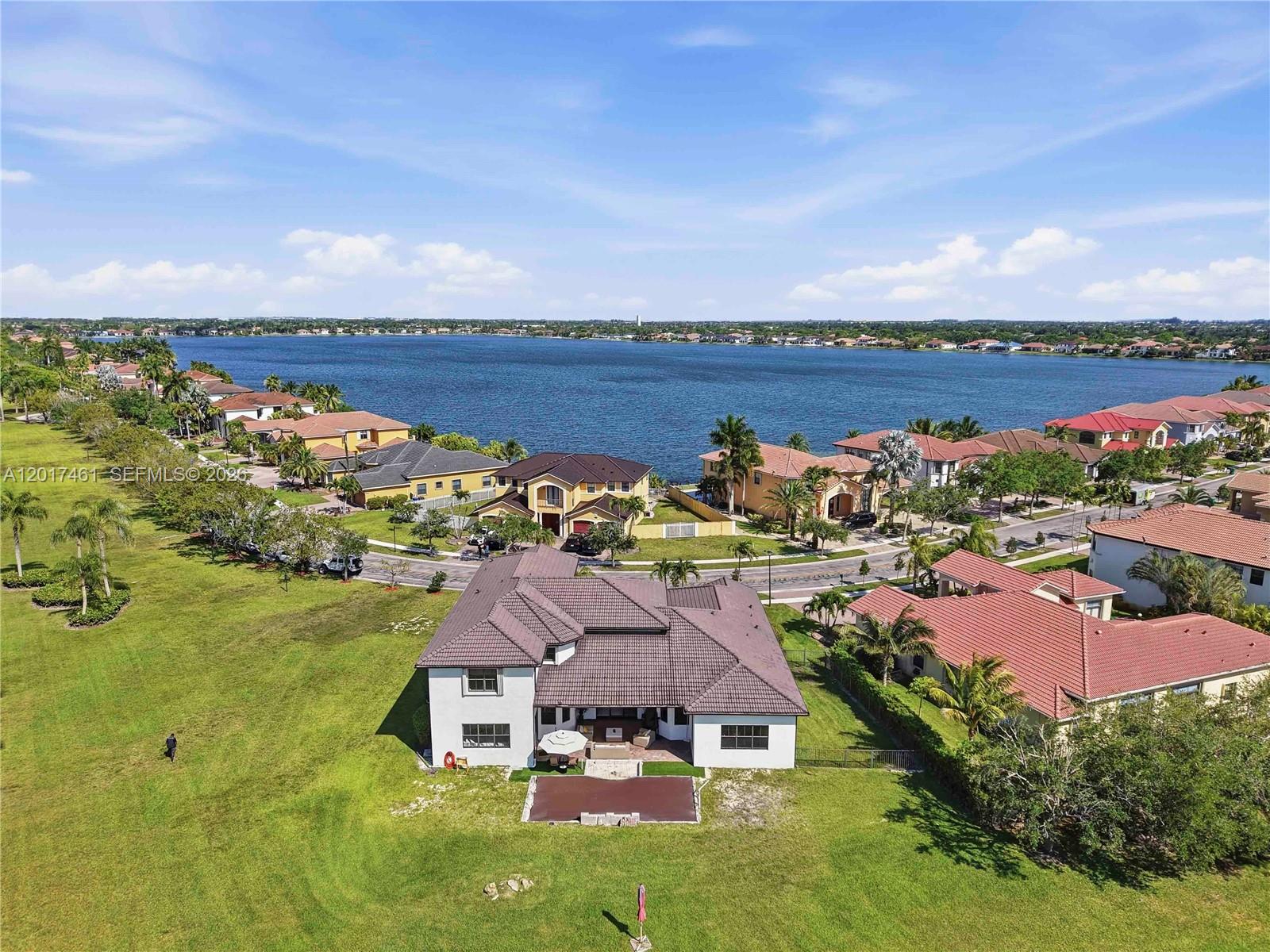An aerial view shows a large house with a brown roof and a backyard lawn — 1748 SW 195th Ave, Miramar FL 33029, MIRAMAR, FL