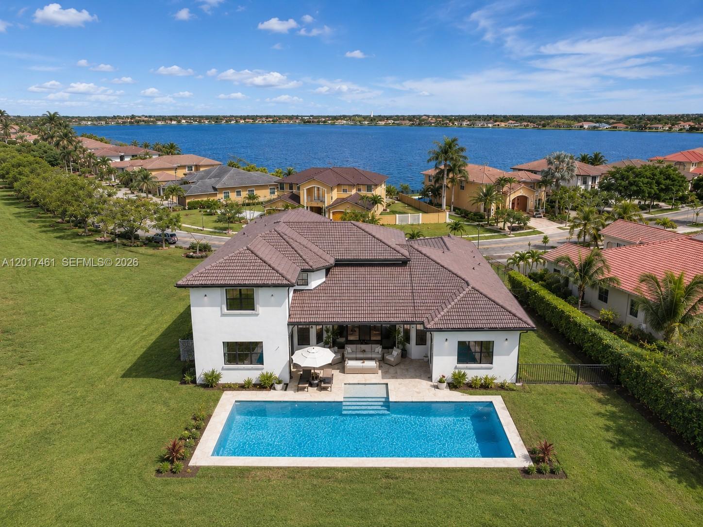 An aerial view shows a white house with a tiled roof, pool, and large lawn — 1748 SW 195th Ave, Miramar FL 33029, MIRAMAR, FL