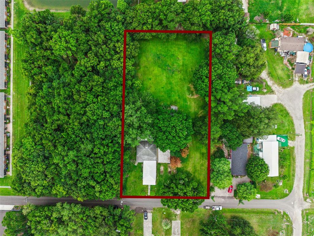 An aerial view shows a rectangular property lot with a house and trees — 420 JACKS MEMORIAL RD, ST CLOUD, FL