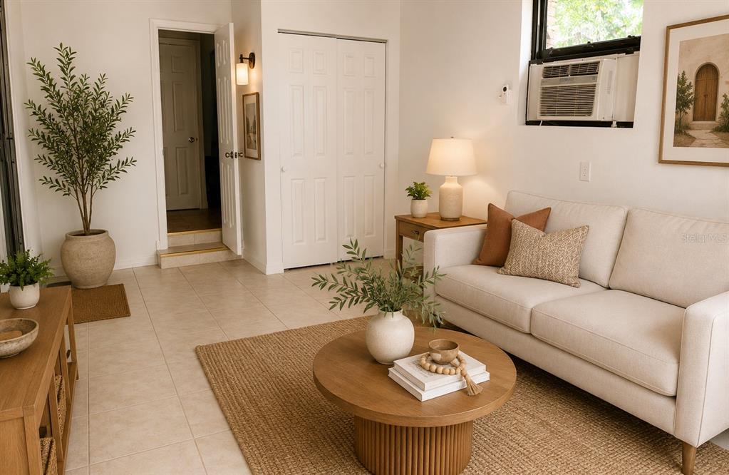 A living room features a beige sofa, a round coffee table, and a potted plant — 14 JAPONICA DRIVE, ORLANDO, FL