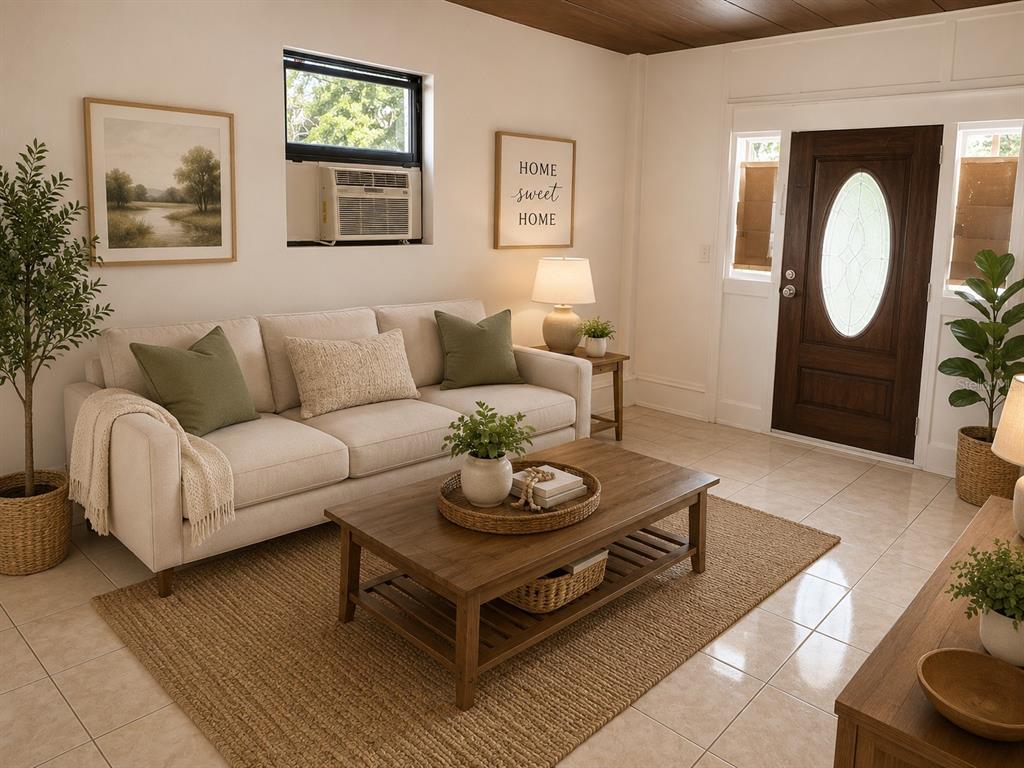 A living room features a beige sofa, a wooden coffee table, and a dark front door — 14 JAPONICA DRIVE, ORLANDO, FL