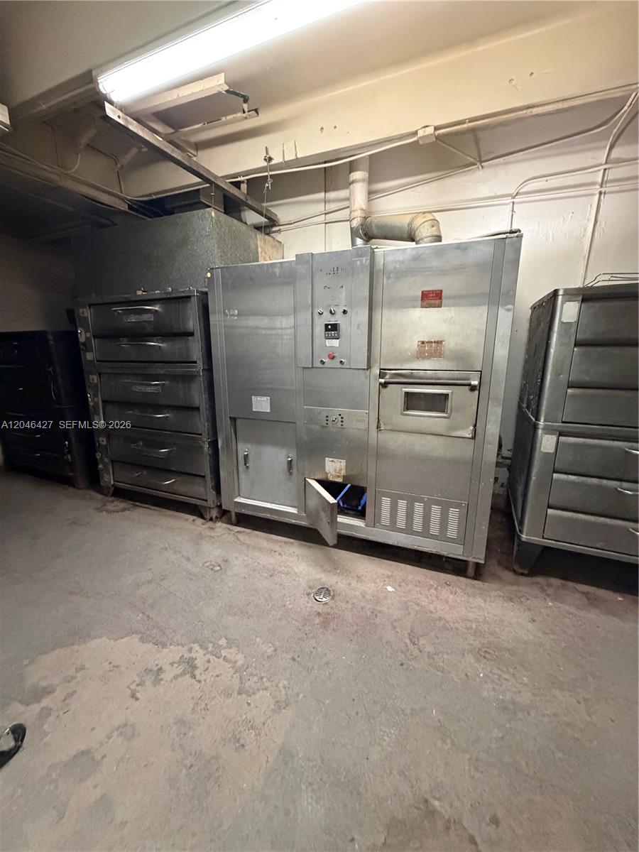 A commercial kitchen contains a large stainless steel oven and two metal storage units — 1262 Palm Ave, Hialeah FL 33010, HIALEAH, FL