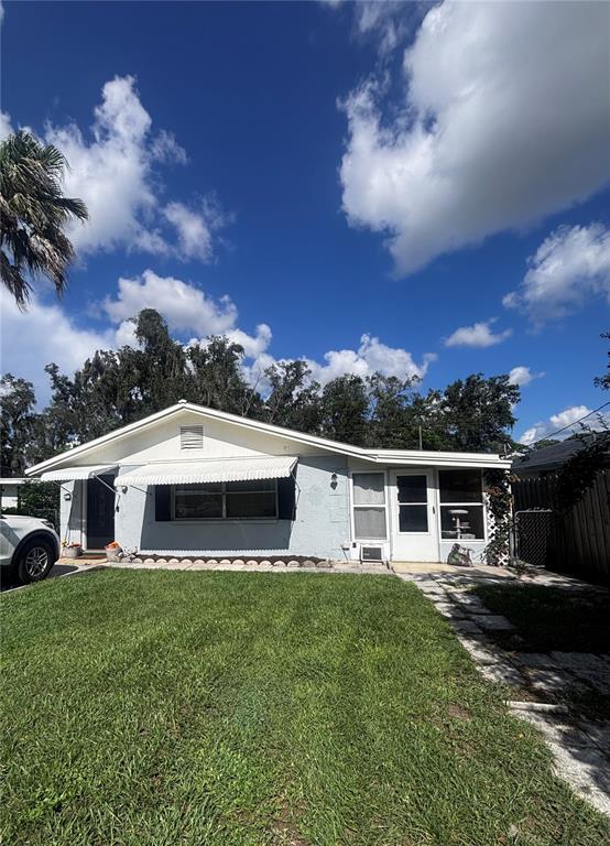 A single-story house with a light blue exterior, white trim, and a front lawn — 4824 8TH STREET, ZEPHYRHILLS, FL