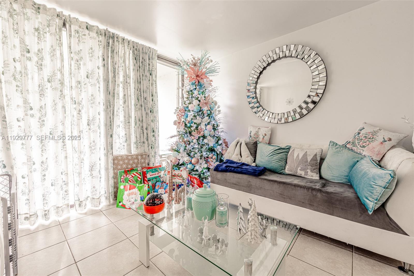 A living room features a Christmas tree, a sofa with decorative pillows, and a glass table — 8006 SW 149th Ave # D109, Miami FL 33193, MIAMI, FL
