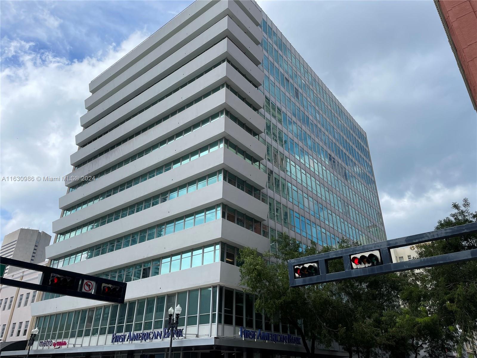 A multi-story office building with horizontal white balconies and blue-tinted glass windows — 14 NE 1st Ave # 300A, Miami FL 33132, MIAMI, FL