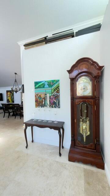 A tall wooden grandfather clock stands next to a console table with art on the wall — 706 Via Genova, Deerfield Beach FL 33442, DEERFIELD BEACH, FL