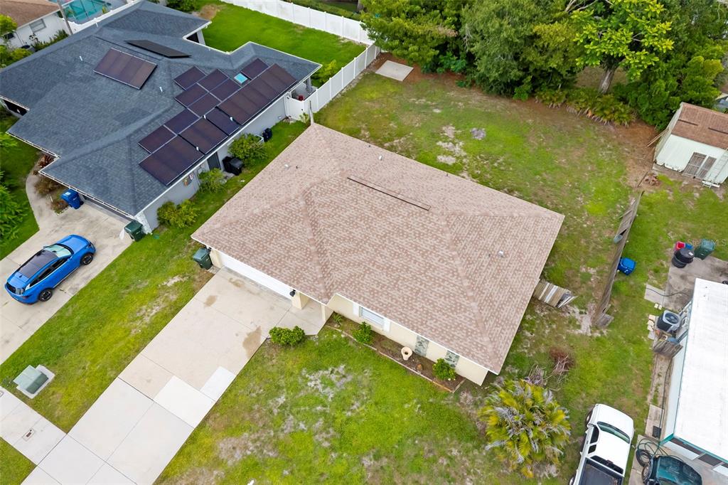 An aerial view shows a single-story house with a brown shingled roof and a driveway — 5000 MINK ROAD, SARASOTA, FL