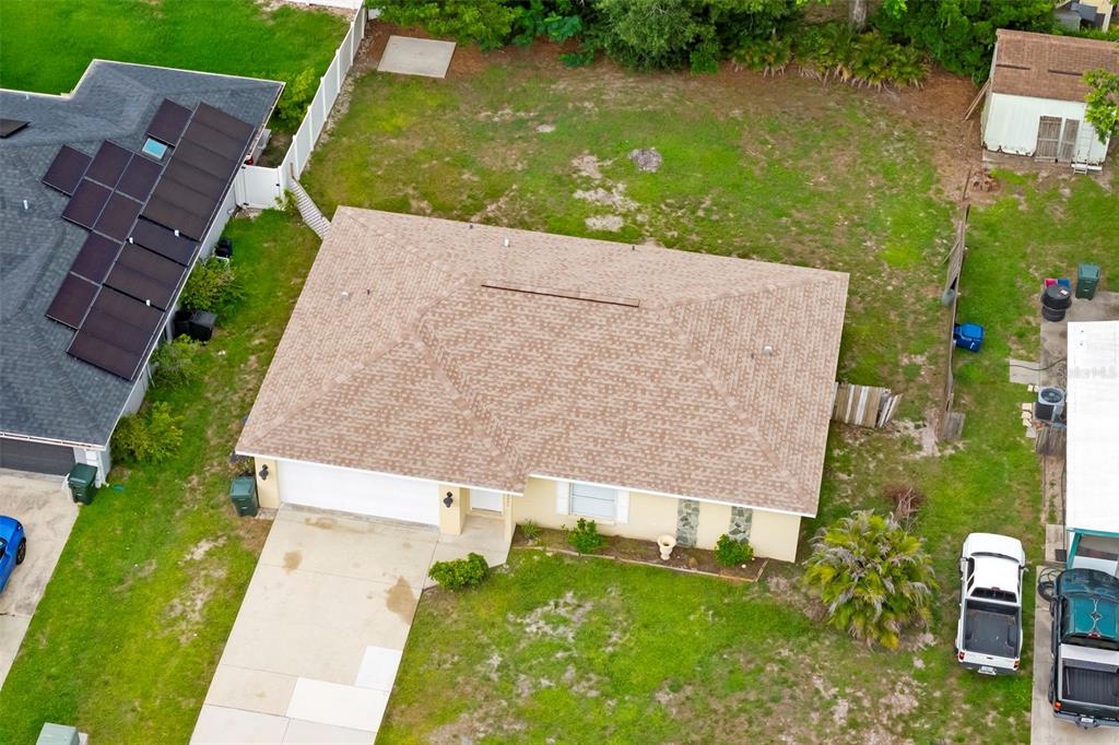 An aerial view shows a single-story house with a tan roof and a concrete driveway — 5000 MINK ROAD, SARASOTA, FL