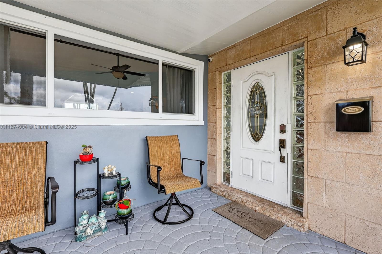 A backyard patio features a covered outdoor kitchen with a pool and wooden fencing — 7120 Wilson St, Hollywood FL 33024, HOLLYWOOD, FL