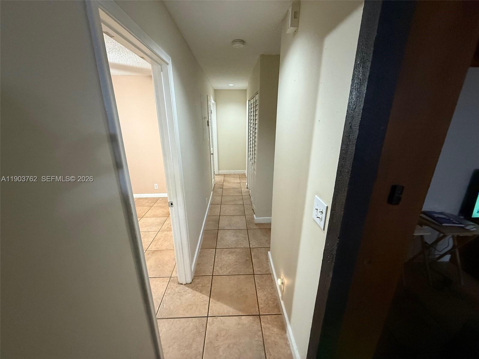 A kitchen features wood cabinets, white appliances, a center island, and tiled flooring — 9422 SW 127th Ave, Miami FL 33186, MIAMI, FL