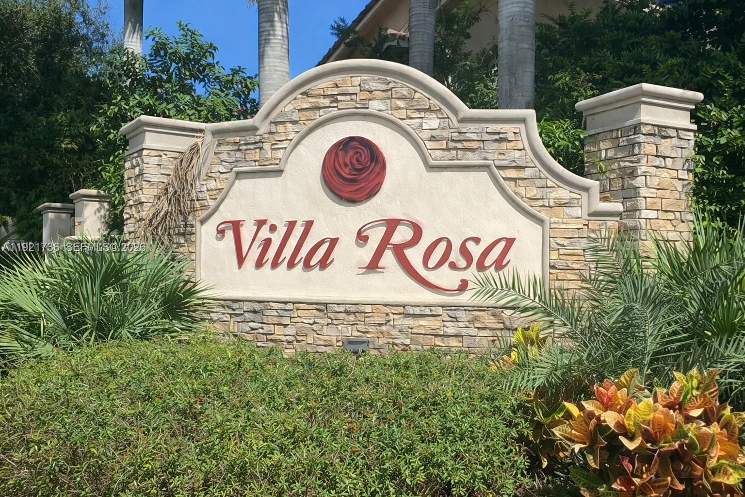 A stone-clad monument sign displays the name Villa Rosa with a red rose emblem — 1718 Carvelle Dr # 1718, Riviera Beach FL 33404, RIVIERA BEACH, FL