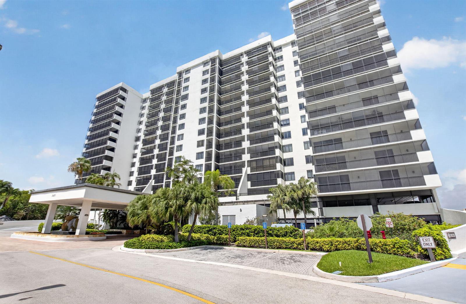 A multi-story white residential building with balconies and a covered entrance driveway — 3420 S Ocean Boulevard # 12t, Highland Beach FL 33487, HIGHLAND BEACH, FL