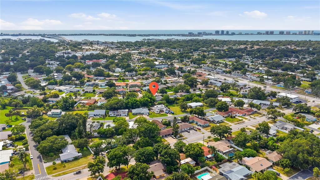 An aerial view shows a residential neighborhood with a red pin marking a specific property — 197 OVERBROOK DRIVE E, LARGO, FL