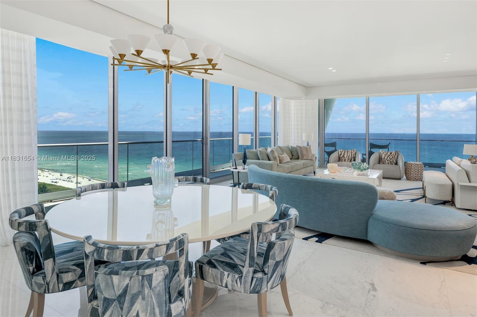 A bright living and dining area features floor-to-ceiling windows overlooking the ocean — 9349 Collins Ave # 1101, Surfside FL 33154, SURFSIDE, FL