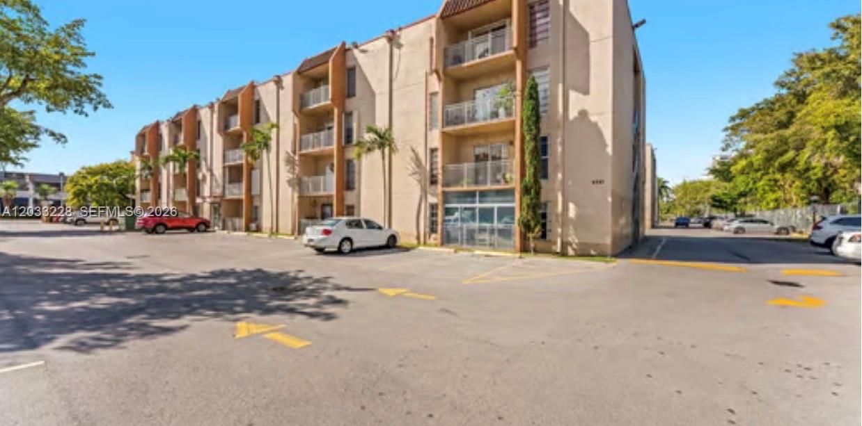 A multi-story apartment building with balconies and a paved parking lot in front — 4841 NW 7th St # 4, Miami FL 33126, MIAMI, FL