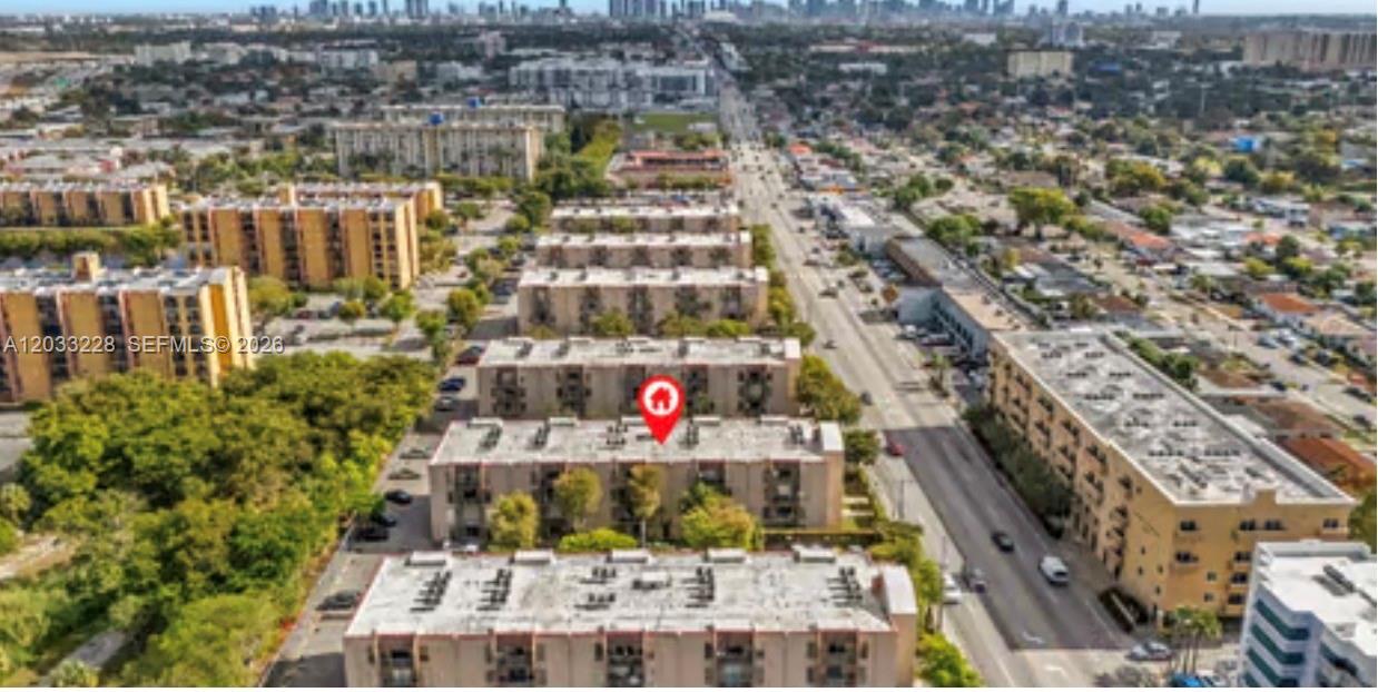 An aerial view shows several multi-story apartment buildings situated along a busy city street — 4841 NW 7th St # 4, Miami FL 33126, MIAMI, FL