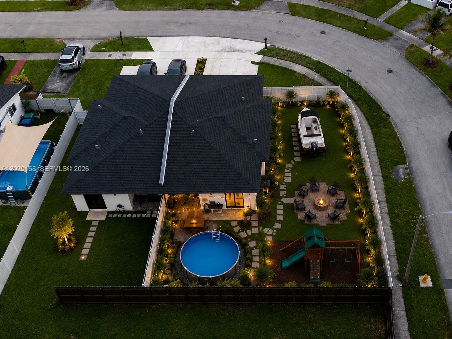 An aerial view shows a house with a fenced backyard, pool, fire pit, and boat — 10769 SW 146th St, Miami FL 33176, MIAMI, FL