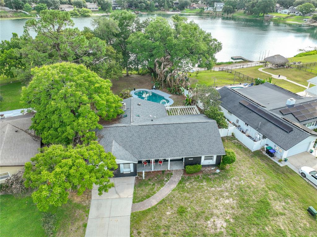 An aerial view shows a single-story house with a pool, large trees, and lake access — 3417 PERSHING AVENUE, ORLANDO, FL