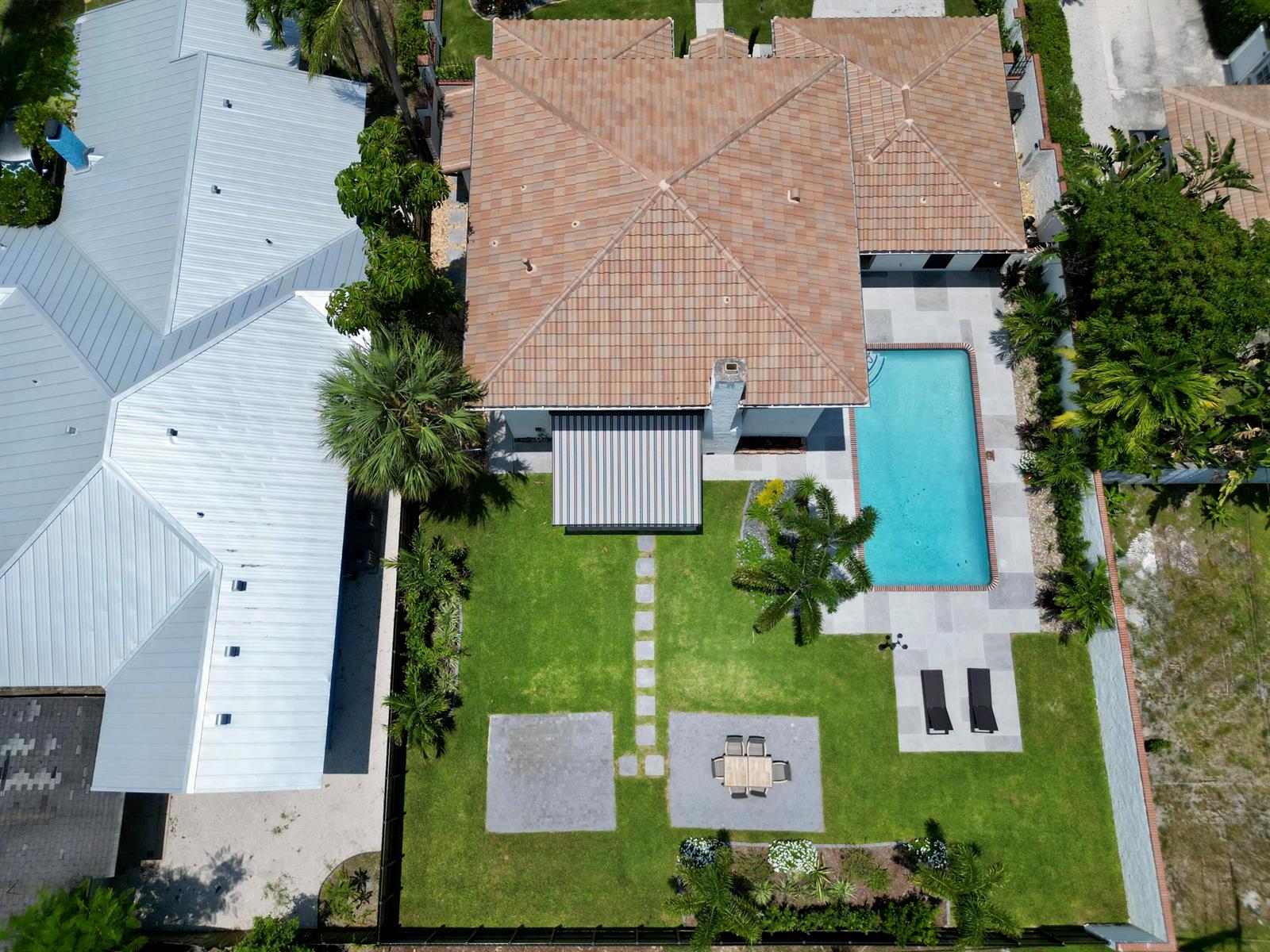 An aerial view shows a house with a tiled roof, a swimming pool, and backyard — 308 Greymon Drive, West Palm Beach FL 33405, WEST PALM BEACH, FL