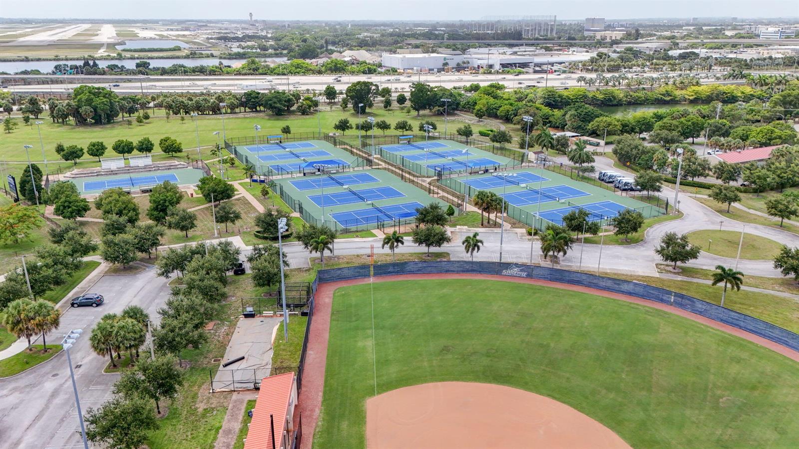An aerial view shows a baseball field adjacent to several fenced tennis courts and parking — 3400 PARKER Avenue, West Palm Beach FL 33405, WEST PALM BEACH, FL