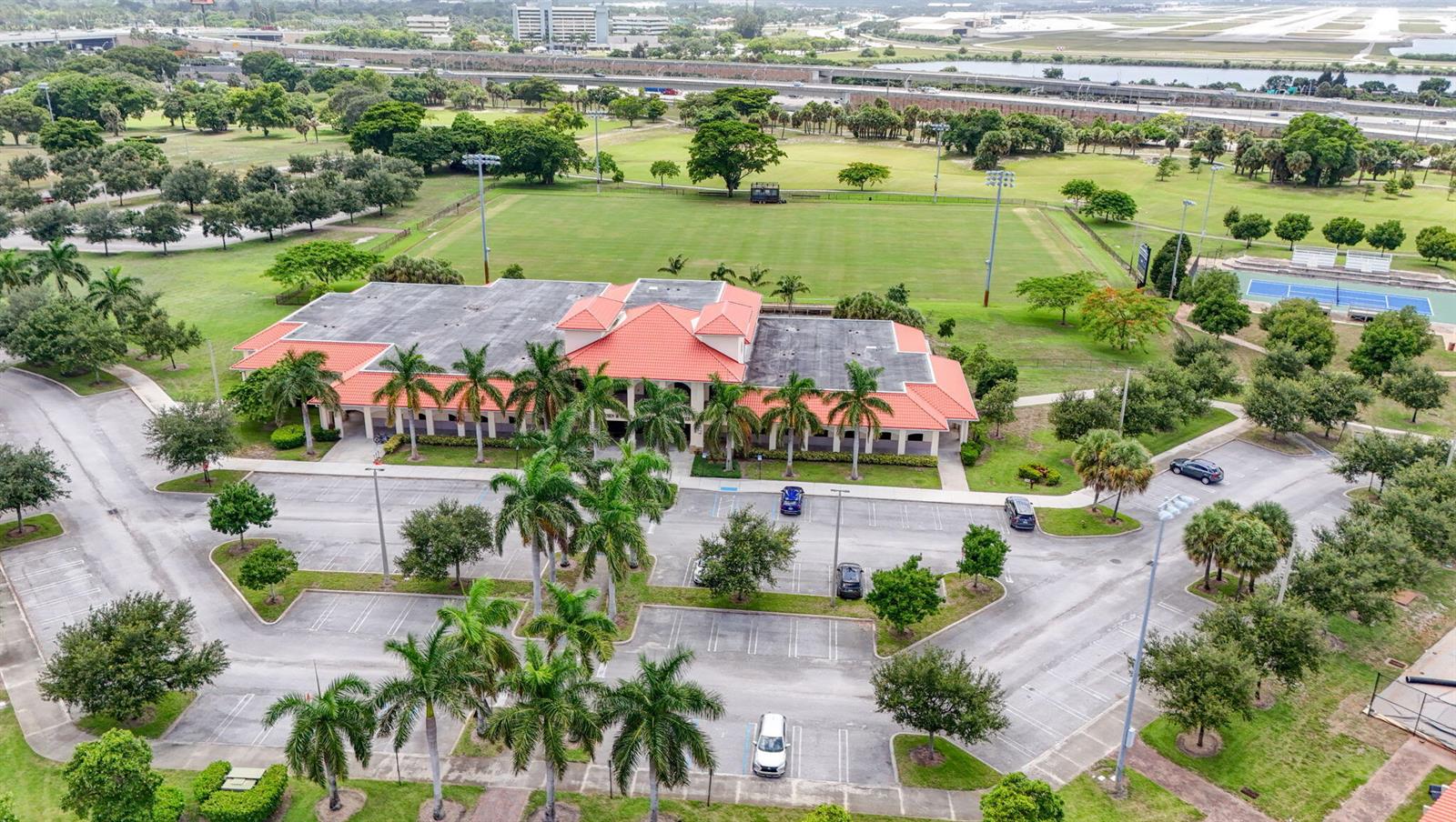 An aerial view shows a community center with a red tile roof, parking lot, and fields — 3400 PARKER Avenue, West Palm Beach FL 33405, WEST PALM BEACH, FL