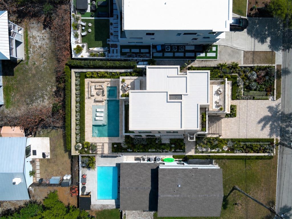 An aerial view shows two adjacent residential properties, each featuring a private swimming pool — 4737 S. PENINSULA DRIVE, PONCE INLET, FL