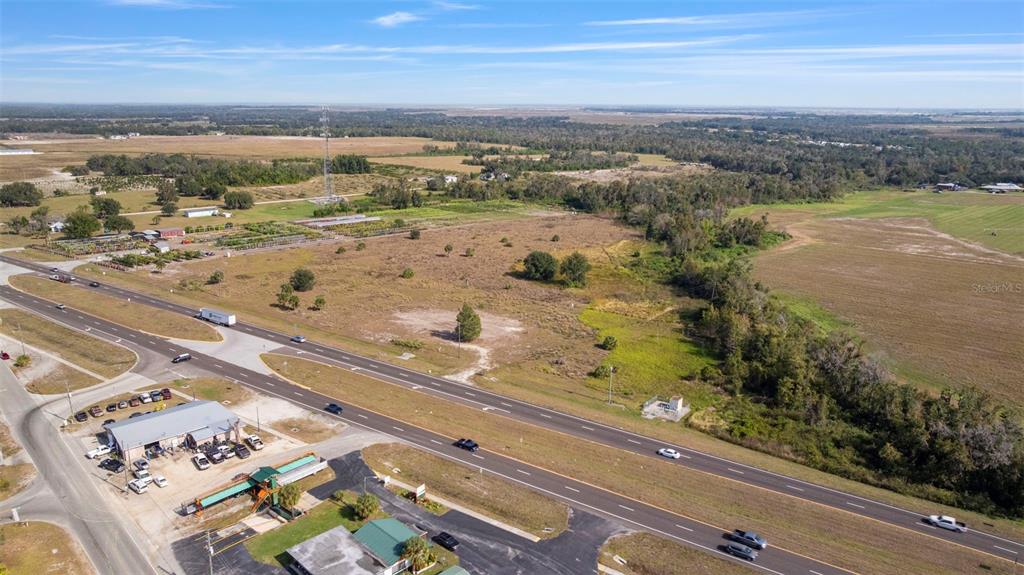 An aerial view shows a large, undeveloped grassy lot adjacent to a multi-lane highway — 1768 N US HWY 17, WAUCHULA, FL