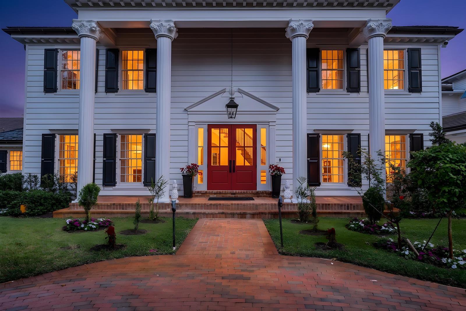 A two-story white house with a red front door, four columns, and a brick walkway — 19153 SE Jupiter River Drive, Jupiter FL 33458, JUPITER, FL