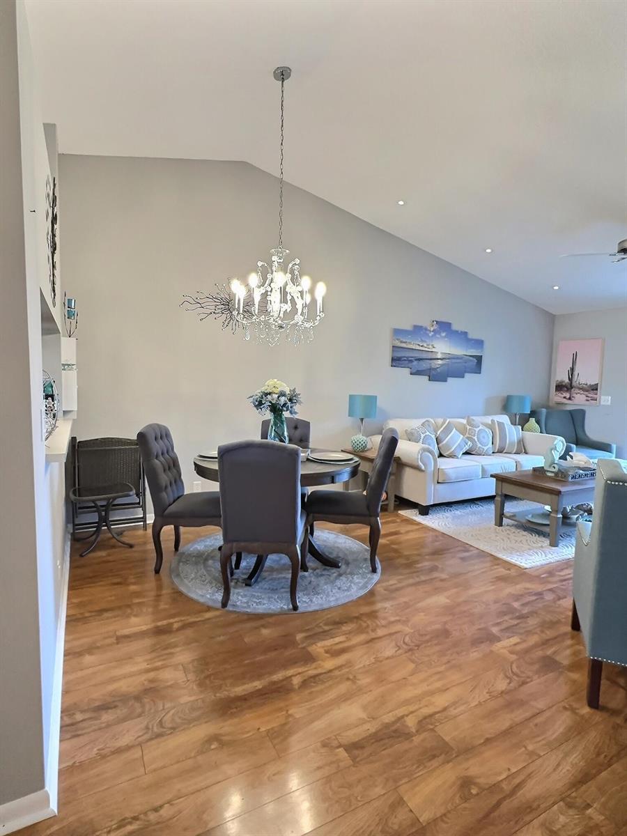 A dining area with a chandelier and round table sits adjacent to a living room — 4682 E Lucerne Lakes Blvd Boulevard E # 202, Lake Worth FL 33467, LAKE WORTH, FL