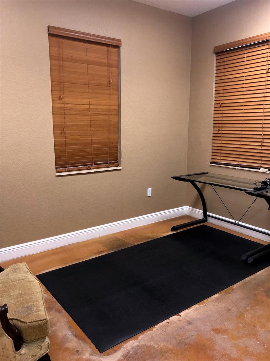 A room with tan walls, wood blinds, a glass desk, and a black floor mat — 6848 Griffin Road # 6, Davie FL 33314, DAVIE, FL
