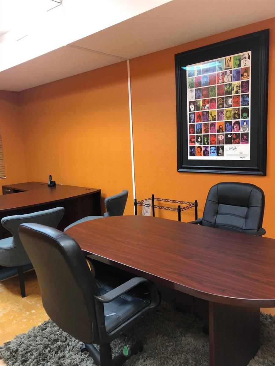 An office room features orange walls, a dark wood desk, and a framed poster — 6848 Griffin Road # 6, Davie FL 33314, DAVIE, FL