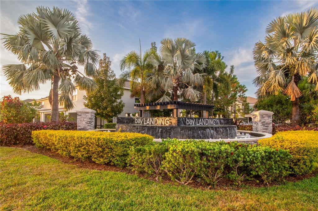 A stone fountain with the Bay Landing sign sits in front of palm trees and buildings — 2801 MIDNIGHT PEARL DRIVE, SARASOTA, FL