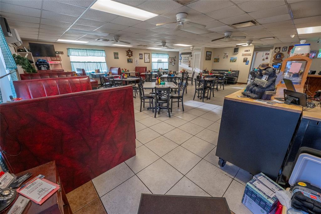 A restaurant dining area features red vinyl booths, square tables with chairs, and tiled floors — 966 REED CANAL ROAD, SOUTH DAYTONA, FL