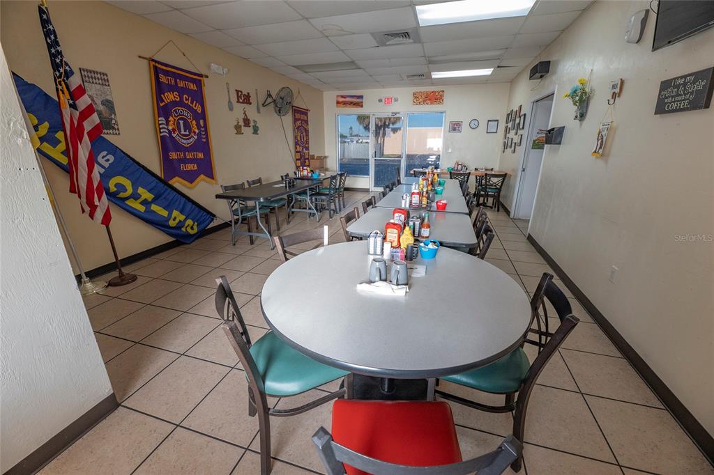 A restaurant dining area features round and rectangular tables with chairs on tiled floors — 966 REED CANAL ROAD, SOUTH DAYTONA, FL