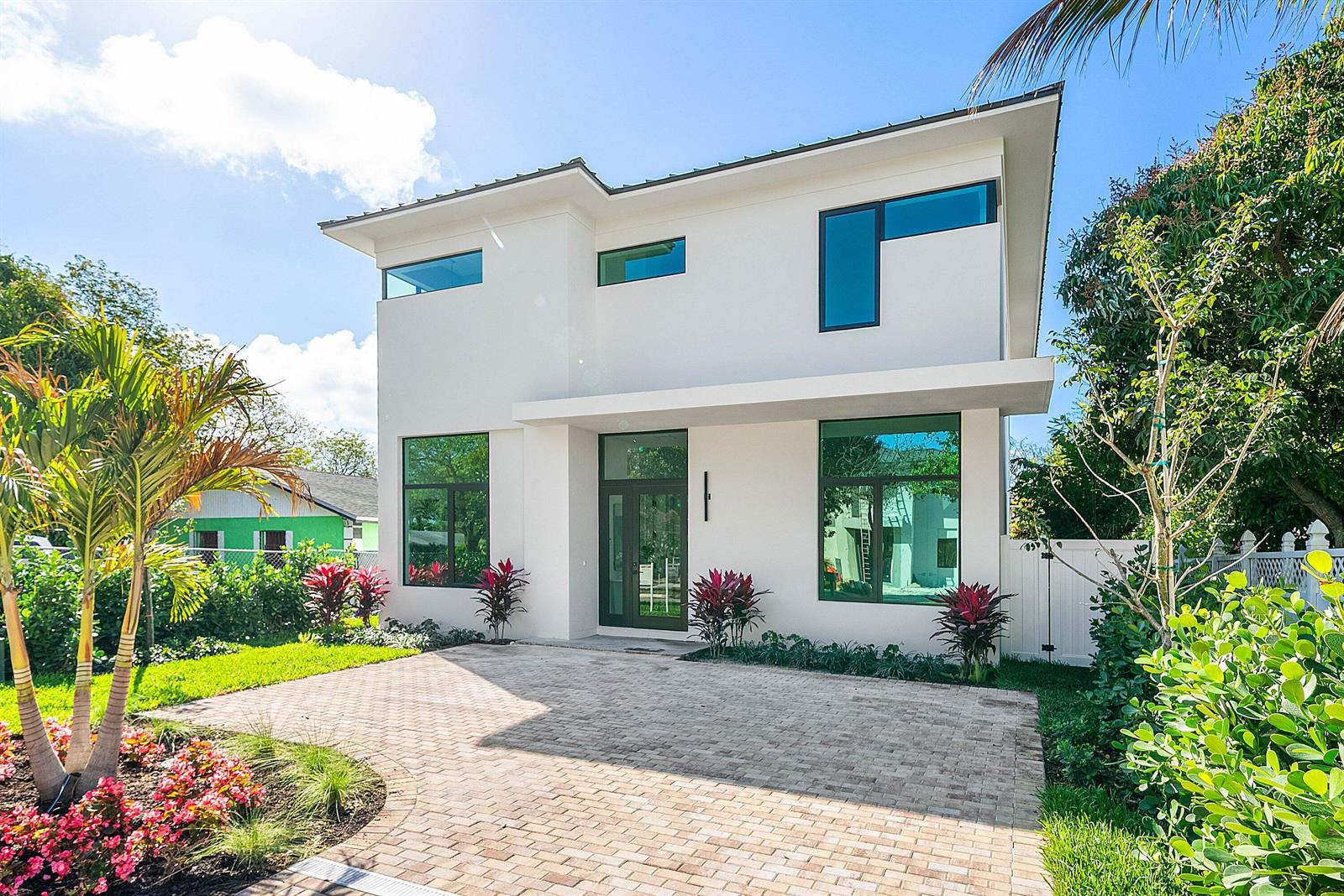 A modern two-story white house with large windows and a paved driveway — 222 SE 5th Street, Delray Beach FL 33483, DELRAY BEACH, FL