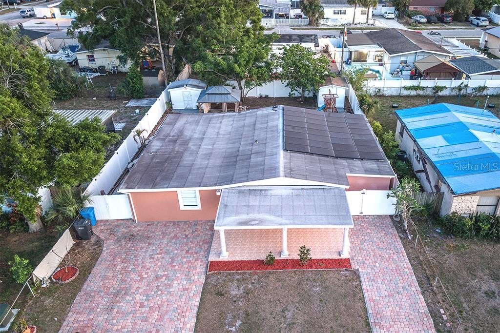 An aerial view shows a house with a solar panel array on its roof — 6506 SALINE STREET, TAMPA, FL
