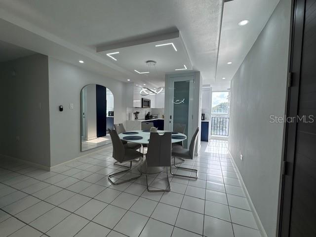 A dining area features a round table, modern chairs, and a recessed ceiling light fixture — A COND VISTA REAL UNIT 10-B, FAJARDO, PR