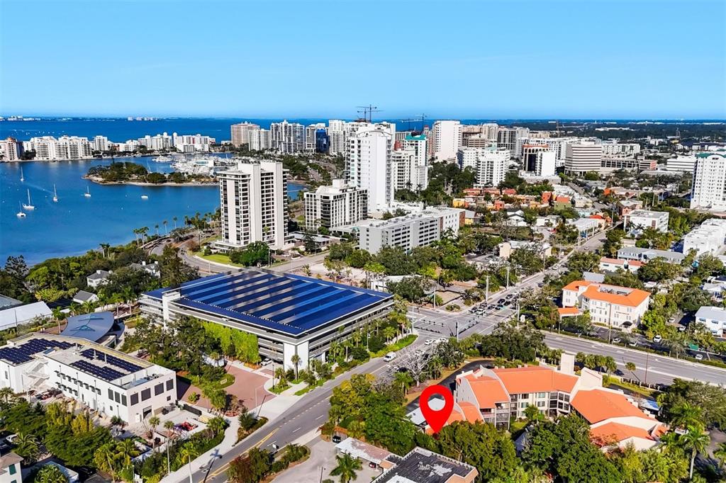 An aerial view shows a coastal city with a red location pin over a building — 800 HUDSON AVENUE UNIT 106, SARASOTA, FL