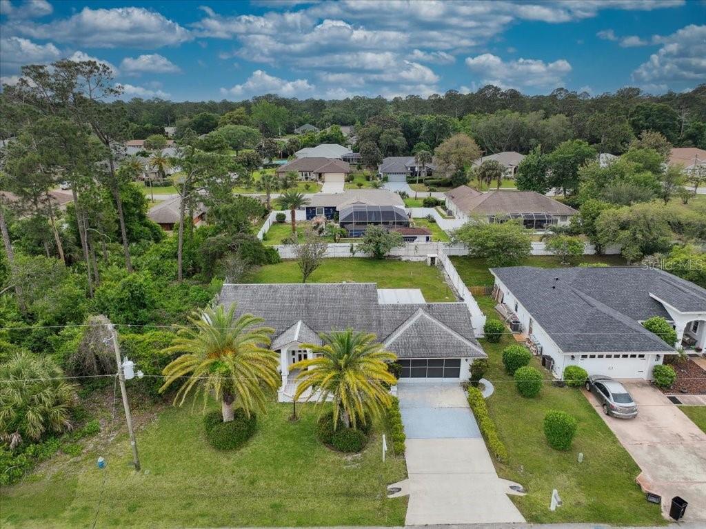 An aerial view of a single-story house with a gray roof and a concrete driveway — 20 FORSYTHE LANE, PALM COAST, FL