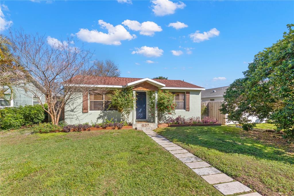 A single-story house with a light green exterior, brown roof, and a stone walkway — 837 42ND AVENUE N, ST PETERSBURG, FL