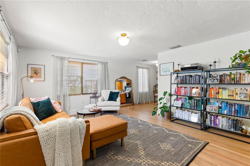 A living room features a leather sectional, a bookshelf, and a large area rug — 837 42ND AVENUE N, ST PETERSBURG, FL