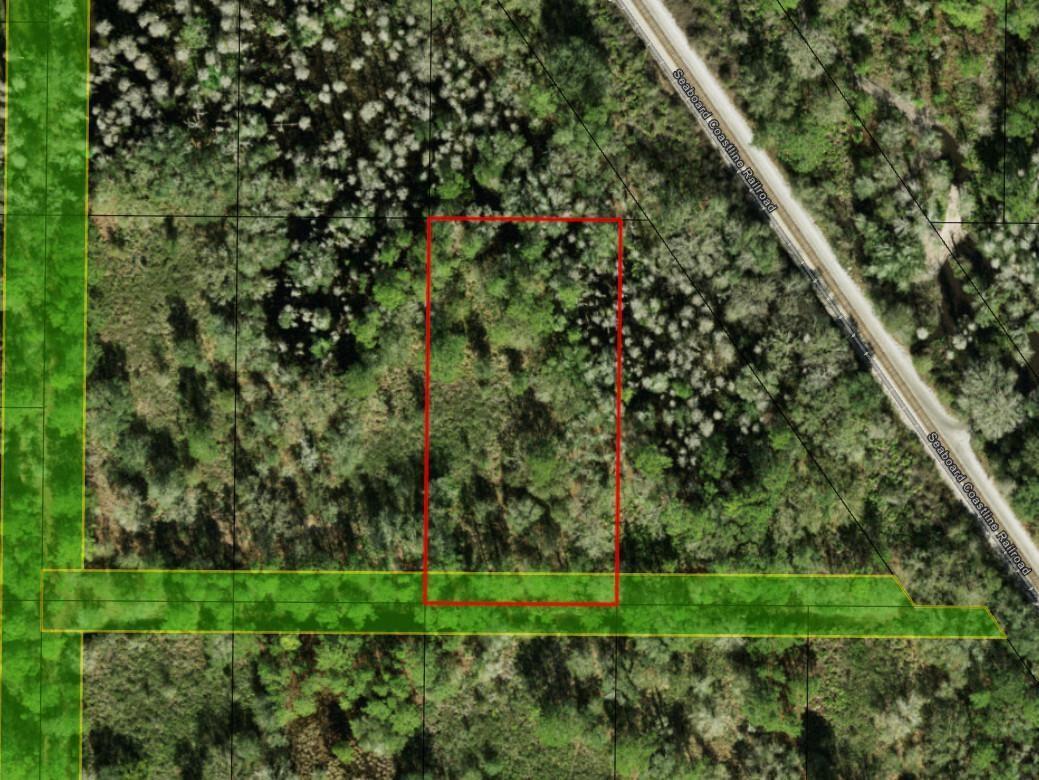 An aerial map view shows a rectangular plot of land outlined in red near railroad tracks — 0 County Rd 54, FL 33849, FL
