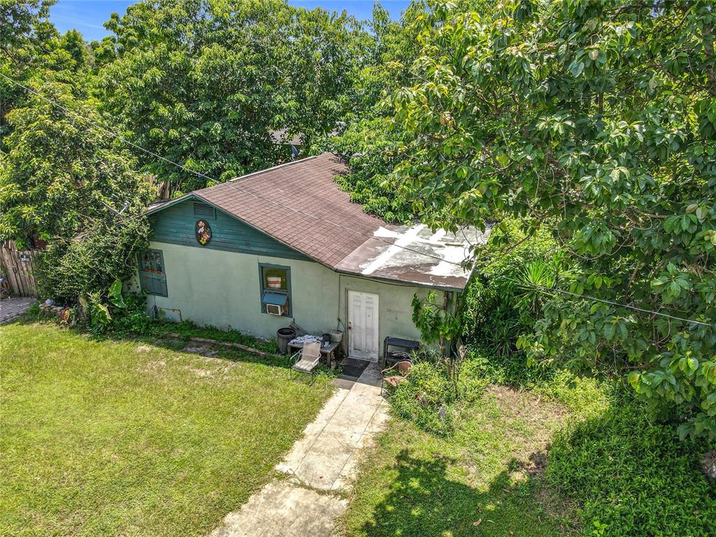 An aerial view of a small, single-story house with a brown roof and overgrown landscaping — 1906 VINE STREET, ORLANDO, FL