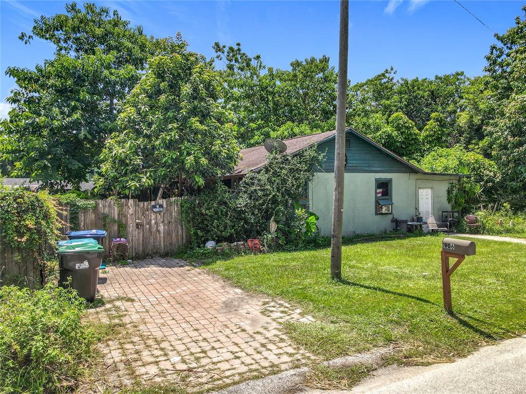 A single-story house with a paved driveway, a wooden fence, and a mailbox in front — 1906 VINE STREET, ORLANDO, FL
