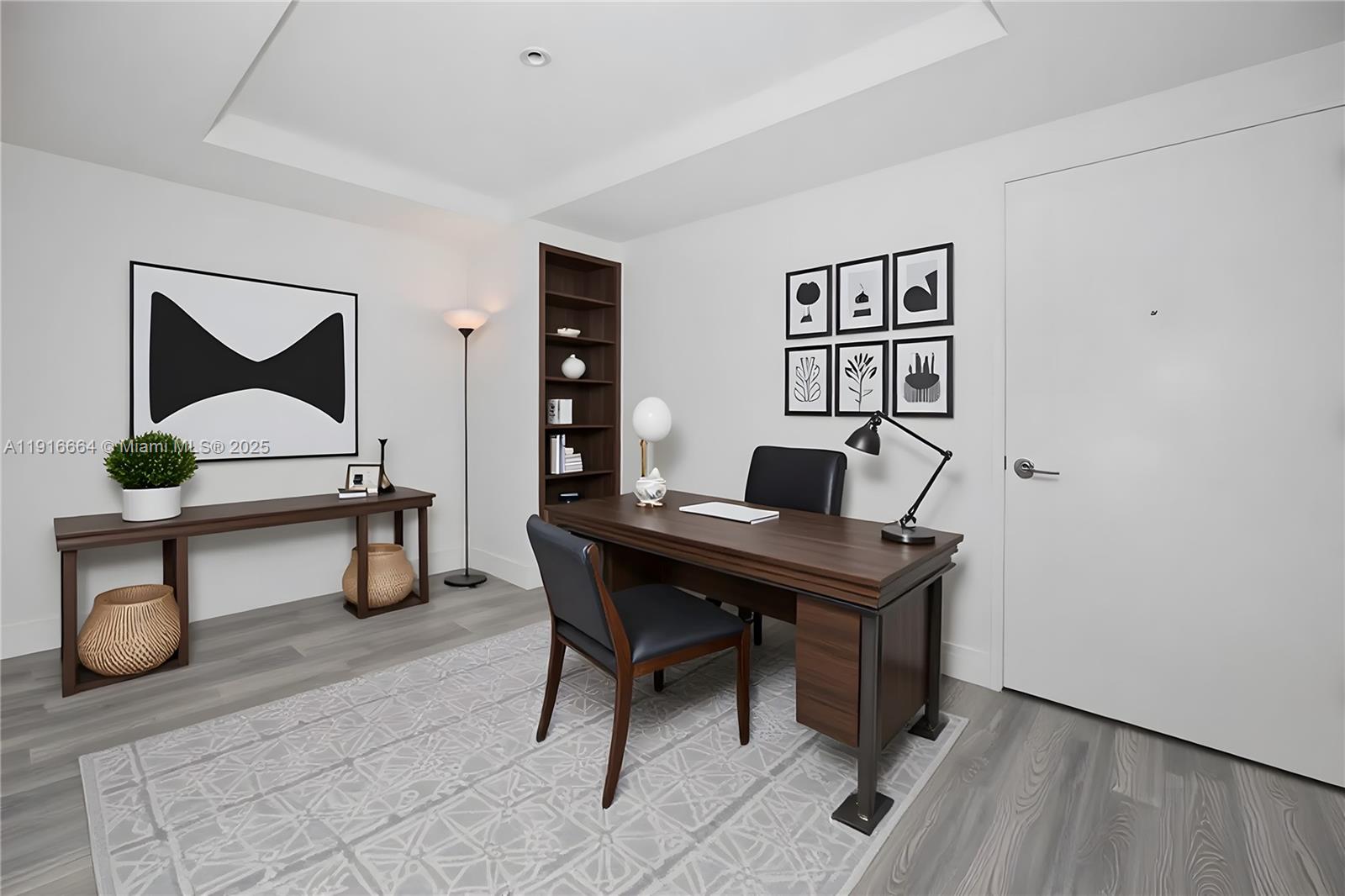A home office features a dark wood desk, matching shelving, and a gray patterned rug — 45 SW 9th St # 1504, Miami FL 33130, MIAMI, FL