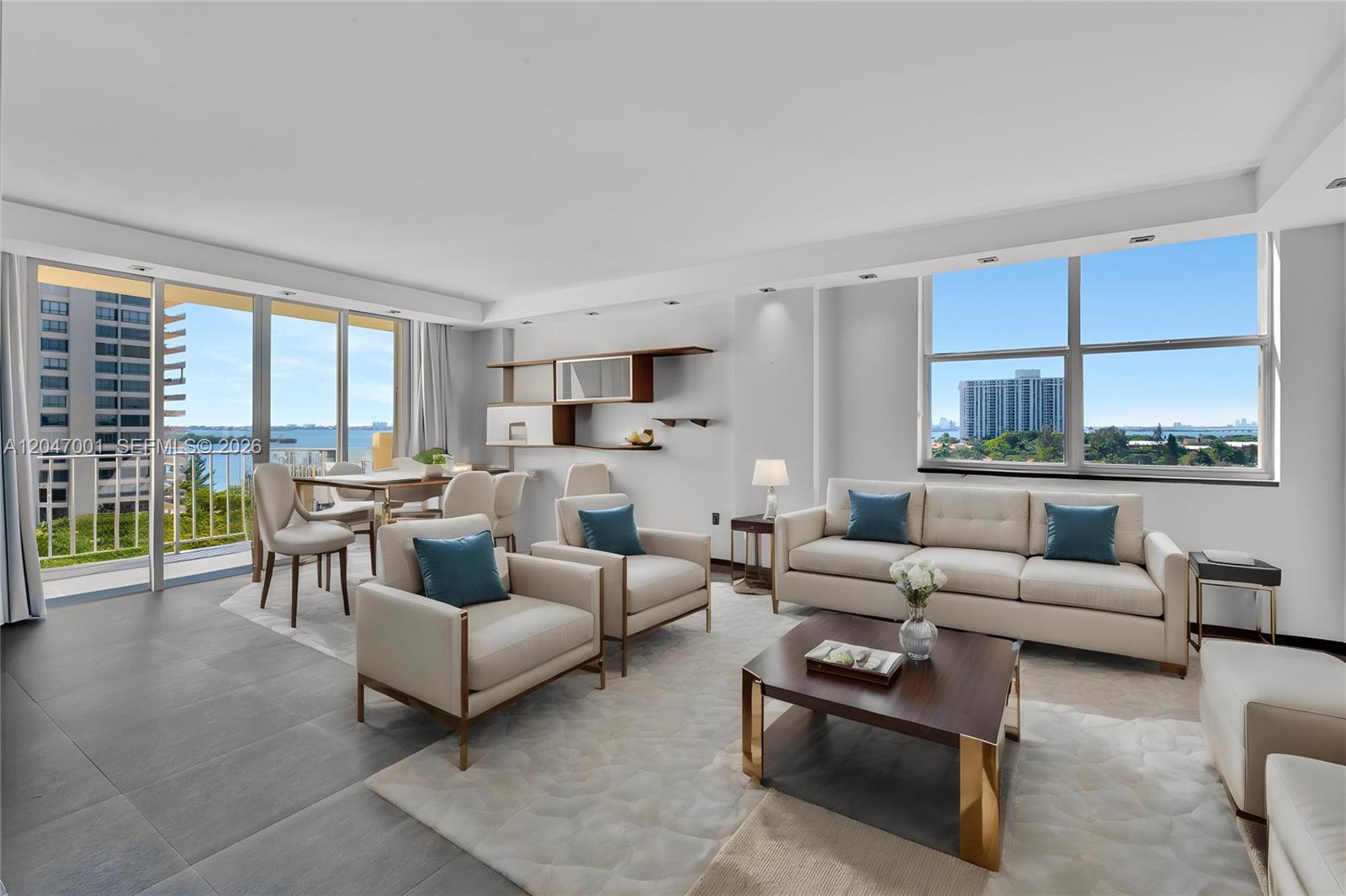 A modern living and dining area features neutral furniture, large windows, and views of water — 11111 Biscayne Blvd, Miami FL 33181, MIAMI, FL