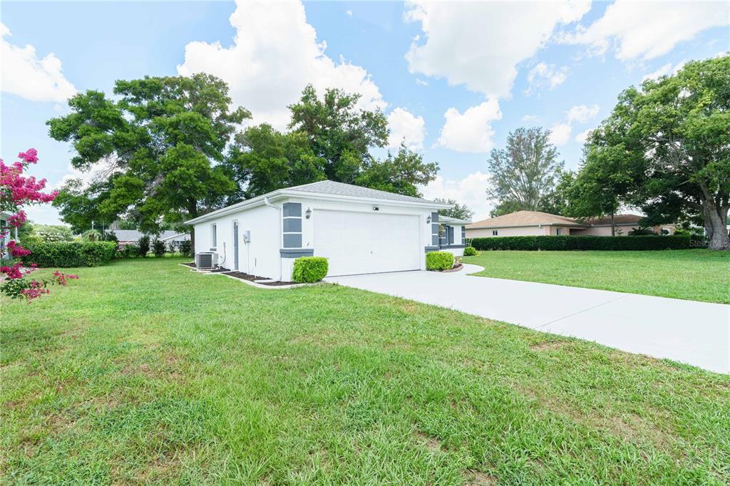 An aerial view shows a residential house with a gray roof and a concrete driveway — 10280 SW 62ND TERRACE ROAD, OCALA, FL