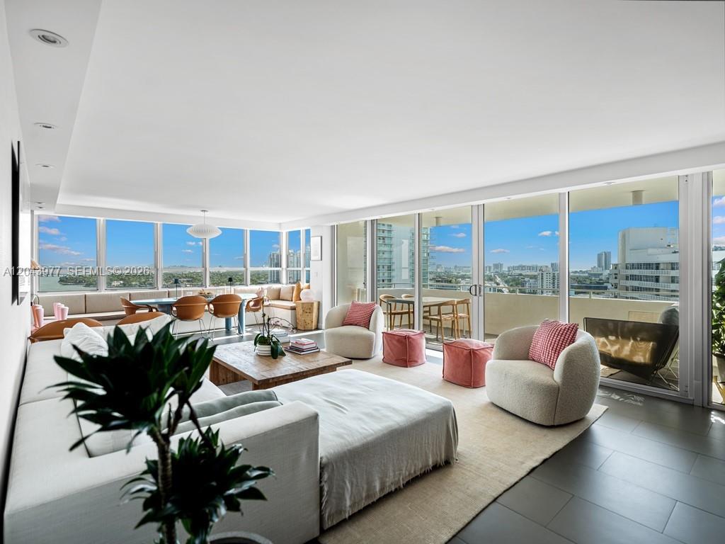 A modern living room features a white sectional sofa, two armchairs, and floor-to-ceiling windows — 11 Island Ave # 1712, Miami Beach FL 33139, MIAMI BEACH, FL